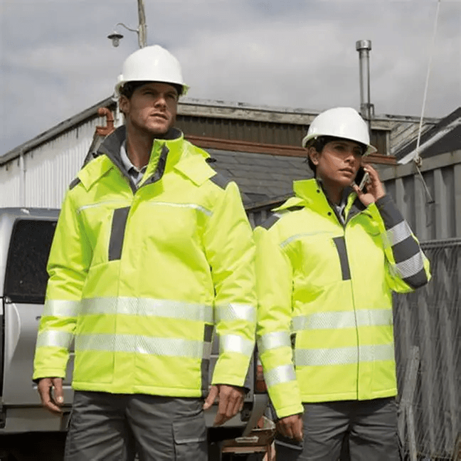 Factory workers in green uniforms at sewing stations