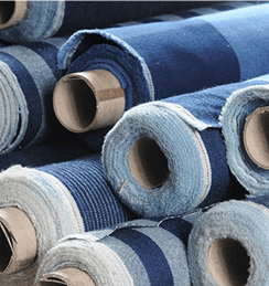 Rolls of blue denim fabric in textile manufacturing